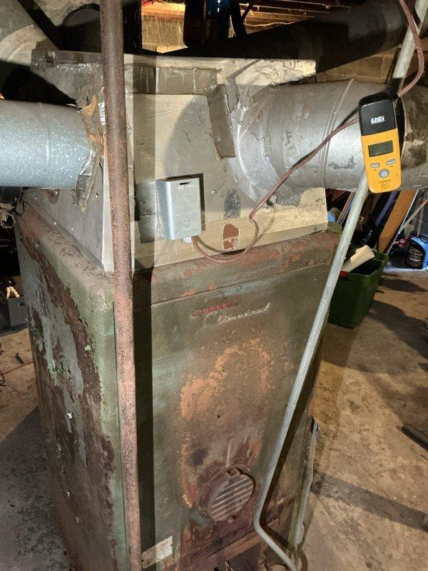 Completed O10 heating tune-up on basement furnace unit. Performed comprehensive inspection of aging system showing significant wear and surface corrosion on cabinet housing. Checked blower motor assembly, drive belt tension and condition, electrical connections, and ductwork. All components operational and system running within acceptable parameters despite age-related deterioration of exterior surfaces.