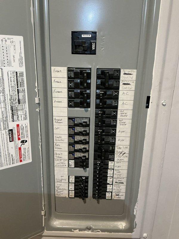 Relocated electrical junction box from behind built-in stove area to adjacent cabinet location to accommodate new kitchen cabinet and stove installation. Verified proper circuit identification at main electrical panel and ensured all connections met code requirements for cooktop circuit accessibility and safety.