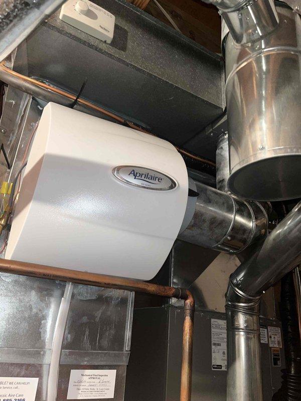 Completed heating tune-up on basement furnace unit. Performed comprehensive system inspection, changed dirty air filter, and verified proper operation of Aprilaire humidifier and all ductwork connections. All components tested and found operating within normal parameters.