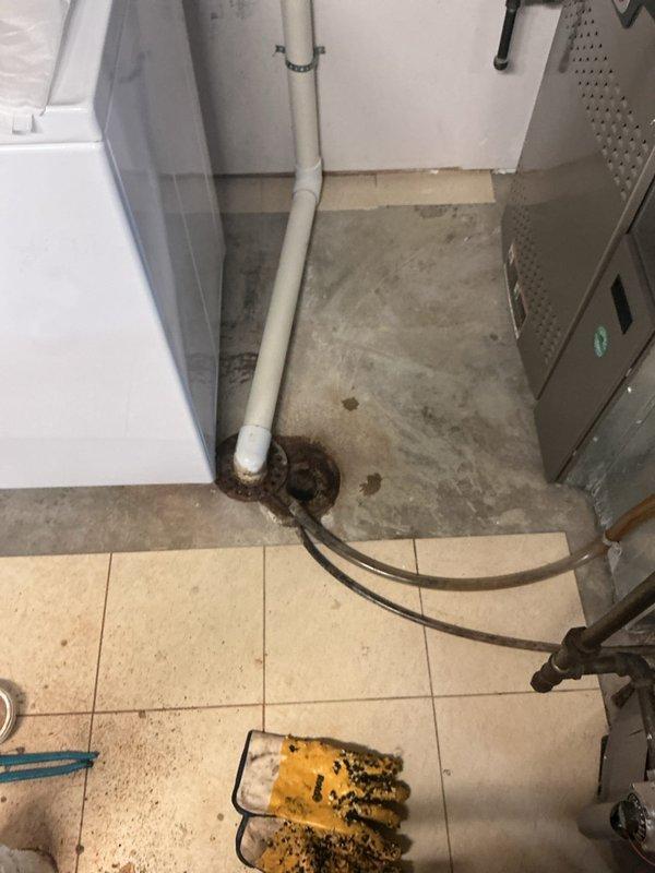 Responded to report of slow-draining basement floor drain. Transported drain cleaning equipment through interior of home to basement level due to lack of exterior yard access. Upon inspection, identified partial obstruction in main drain line causing reduced flow capacity. Performed mechanical cable cleaning of basement drain system to remove buildup and restore proper drainage. Verified full flow restoration upon completion of cleanout procedure.
