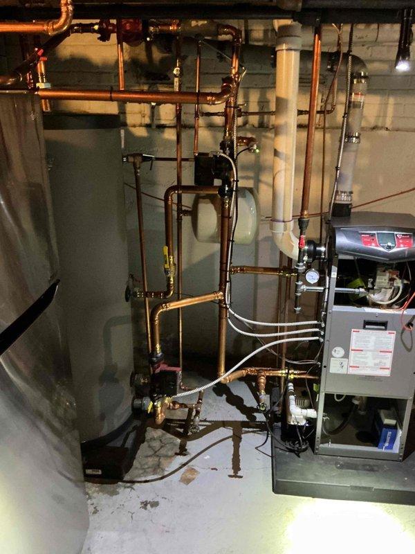 Completed annual preventive maintenance on a 3-year-old residential boiler system located in basement mechanical room. Performed comprehensive tune-up including inspection of all electrical components, control boards, and safety systems. Verified proper operation of burner assembly, tested all safety controls, checked venting system integrity, and inspected copper piping connections and brass valves throughout the hydronic heating system. All components found operating within normal parameters with no issues identified. System returned to full operational status.