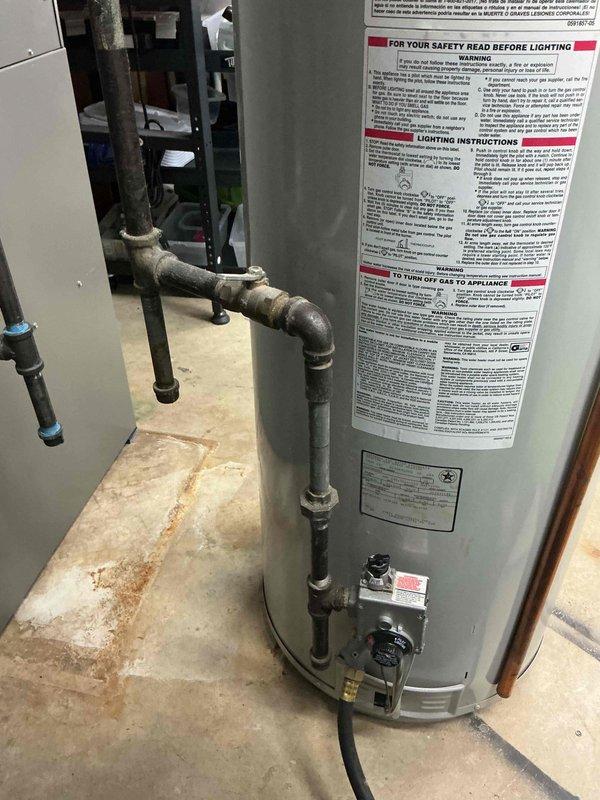 Completed installation of 50-gallon tall gas water heater in basement utility area. Performed all necessary plumbing connections including supply and discharge piping, gas line hookup, and proper venting to existing ductwork. Applied required permit identification sticker per permit #26PLU-20085 and verified all connections meet code requirements for safe operation.