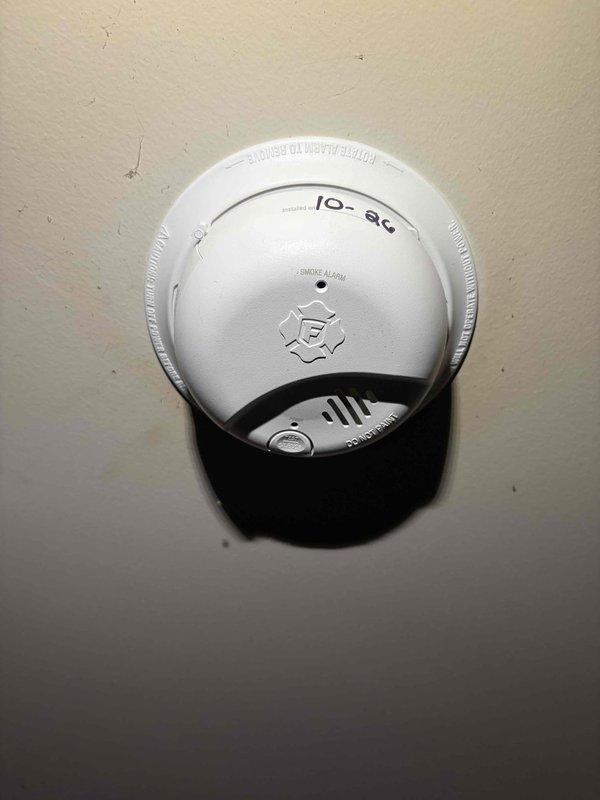 Replaced hardwired smoke alarms with customer-supplied units, securing each to its mounting base and labeling the installation date on the unit. Inspected and addressed the non-functioning wall switches at the double-gang switch plate, verifying proper operation and a secure, intact cover plate.