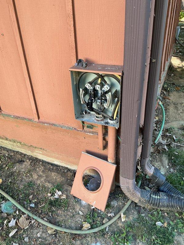 Evaluated the exterior meter socket for replacement of three lugs per utility specifications. Inspection revealed corroded meter jaw brackets, heat discoloration and debris within the enclosure, a rusted conduit opening with frayed conductor strands, and taped conductor splices, indicating the socket requires further repair or replacement beyond lug replacement. Documented existing conditions for estimate preparation.