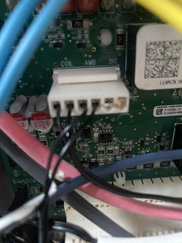 Responded to callback for a no-cooling complaint affecting the whole house on a recently installed and recently serviced AC system. Inspected the Lennox control board and its low-voltage sensor connections (COIL, AMB, DIS), with no visible damage, corrosion, or frost, and performed electrical diagnostics with a multimeter, where an overload (open circuit) resistance reading indicated a break in continuity in the tested circuit. Isolated the fault and restored system operation to verify proper cooling.