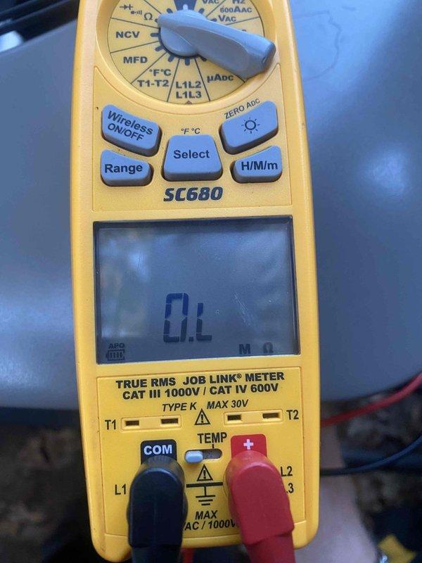Responded to callback for a no-cooling complaint affecting the whole house on a recently installed and recently serviced AC system. Inspected the Lennox control board and its low-voltage sensor connections (COIL, AMB, DIS), with no visible damage, corrosion, or frost, and performed electrical diagnostics with a multimeter, where an overload (open circuit) resistance reading indicated a break in continuity in the tested circuit. Isolated the fault and restored system operation to verify proper cooling.