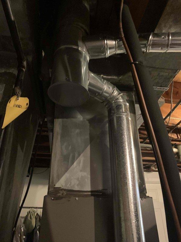 Performed a seasonal tune-up on an 11-year-old furnace, inspecting the control board, wiring harness, flue connection, and venting for proper operation and safe connections. Noted heavy rust and corrosion on the lower cabinet panel and blower compartment guard, along with dust and debris buildup on the plenum and surrounding components, and recommended monitoring the corrosion for possible moisture or condensation issues.
