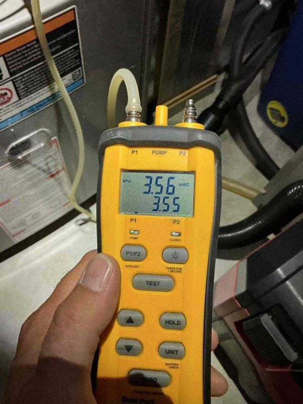 Performed a seasonal tune-up on a single gas furnace, including removal of the front access panel and inspection of the inducer motor, gas valve assembly, burner compartment, blower motor, control board, and low-voltage wiring. Verified gas manifold pressure with a digital dual-port manometer, with readings near 3.5 inWC. Noted surface rust on the gas valve and adjacent components, along with loosely bundled wiring in the burner compartment, and recommended monitoring these conditions during future maintenance.