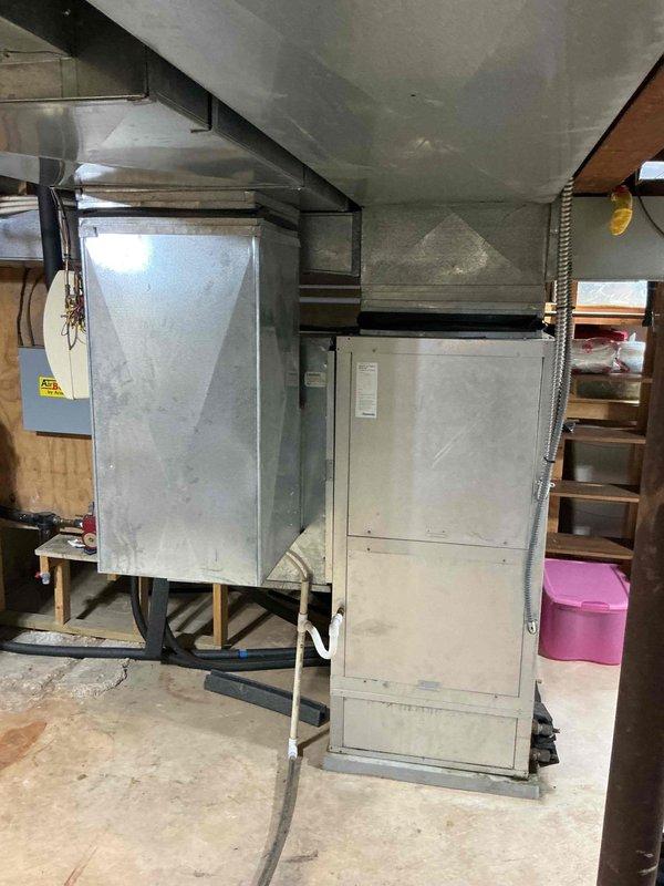 Performed a heating tune-up on a geothermal heat pump system with a functioning air handler, inspecting the control compartment, contactors, relays, wiring terminations, and run capacitors (35 and 40 µF) for signs of wear, overheating, or loose connections. Verified the control board was powered and operating, checked the refrigerant piping, compressor, water modulating valve, and condensate drain line, and found no frost, corrosion, or damage. The system was operating properly at completion.