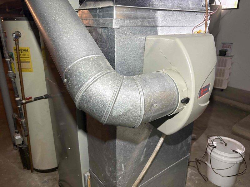 Performed a heating tune-up on the furnace, inspecting the plenum, ductwork, and bypass humidifier connection, and found no visible rust, frost, or damage to the equipment. Inspected the air filter and found it heavily loaded with dust and debris, indicating it is due for replacement to maintain proper airflow and system efficiency.