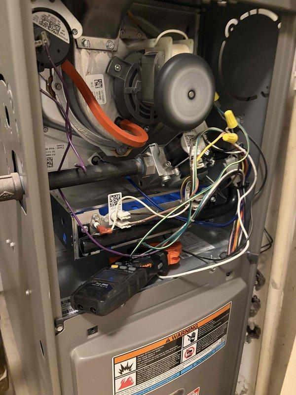 Performed a seasonal tune-up on a 2-year-old Lennox gas furnace, inspecting the inducer motor, pressure switch and hose, gas valve and piping, burner and heat exchanger area, and control wiring and connections. Verified electrical operation with a clamp meter, checked the condensate drain and vent piping, and confirmed all components were in good working order with no visible damage, rust, or leaks. System was reassembled and left operating normally.