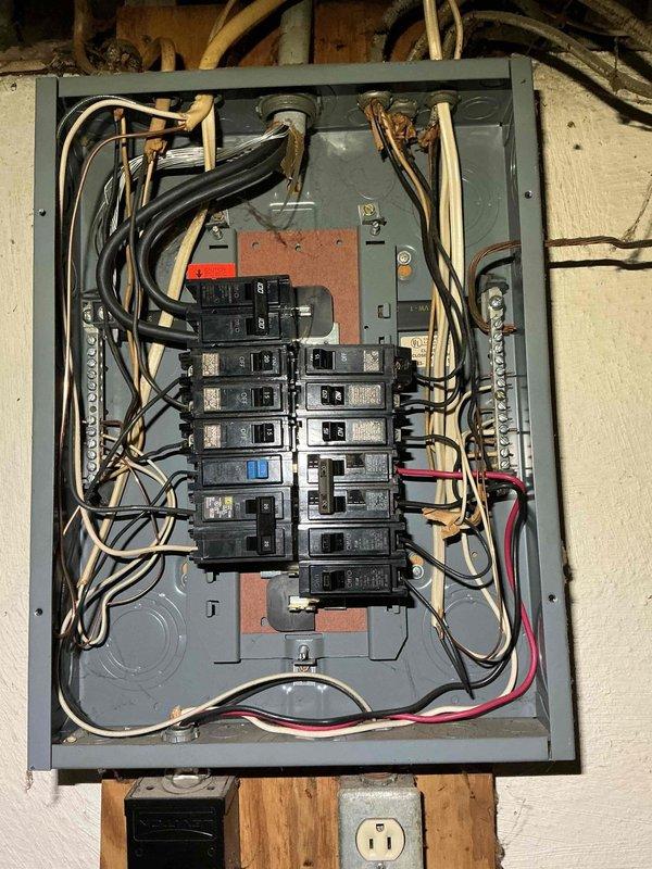 Inspected the non-functioning electrical service panel and found disorganized, loosely routed conductors with mixed legacy cloth-insulated and newer cable types, indicating the unit is at end of service life. Recommended full panel replacement with proper conductor routing, labeling, and neutral/ground bus termination to restore safe, code-compliant operation.