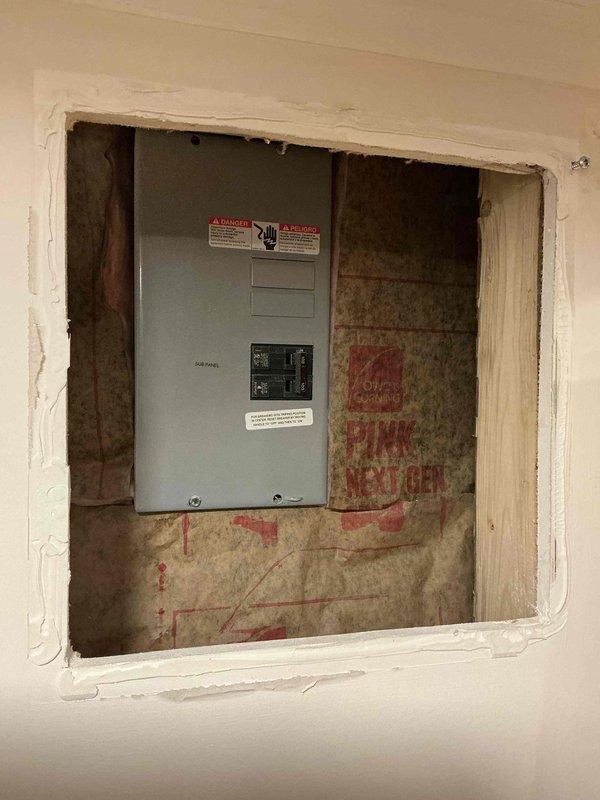 Performed an on-site evaluation for installation of a generator interlock kit and power inlet box on the right side of the structure. Inspected the existing electrical sub panel and the exterior wall, including the surface-mounted enclosure with PVC conduit run along the siding and foundation, to determine panel compatibility, conduit routing, and inlet box placement. Documented existing conditions with photos to prepare a written estimate for the generator connection.