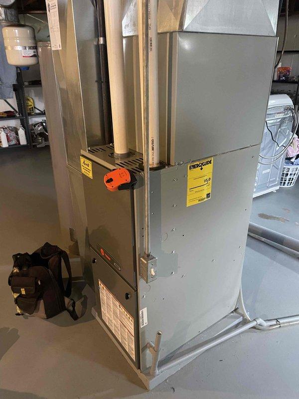 Performed a seasonal heating tune-up on one gas-fired furnace with attached air handler. Inspected the cabinet, PVC vent and condensate piping, electrical conduit, and junction box, finding no visible rust, frost, or damage. Verified the programmable thermostat operates properly, with the display and set point (75°F) responding normally, and confirmed the system is ready for heating season.