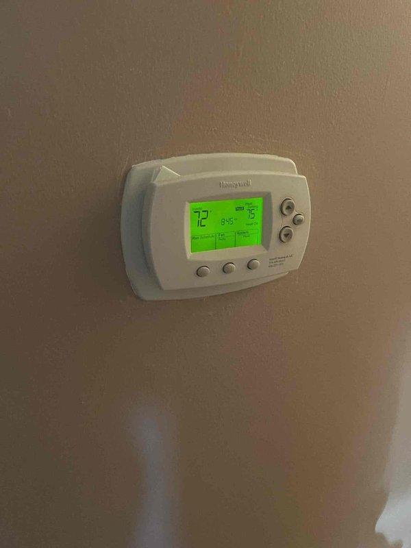 Performed a seasonal heating tune-up on one gas-fired furnace with attached air handler. Inspected the cabinet, PVC vent and condensate piping, electrical conduit, and junction box, finding no visible rust, frost, or damage. Verified the programmable thermostat operates properly, with the display and set point (75°F) responding normally, and confirmed the system is ready for heating season.