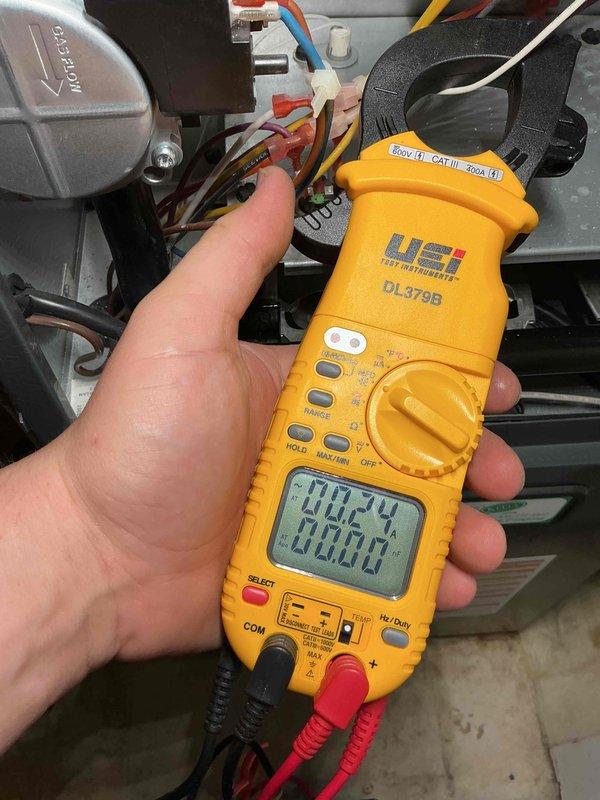 Performed a seasonal heating tune-up on a Goodman furnace, inspecting internal wiring and components and measuring amp draw with a clamp meter to verify proper electrical operation. Checked supply duct temperatures to confirm normal heating performance; the system was operating properly with no faults or symptoms found. Noted cracked and deteriorated insulation on the refrigerant line set, which should be replaced to prevent energy loss and condensation issues.