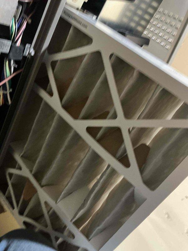 Performed a cooling tune-up on a single residential split system (under 10 years old). Inspected the air handler and found the pleated return air filter loaded with dust and debris. Evaluated the outdoor condenser, which showed heavy dirt and grime buildup on the coil surface along with accumulated leaves and organic debris at the base. Took system performance measurements with a digital meter at the condenser to verify operation and documented unit conditions with photos.
