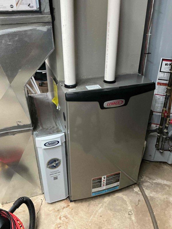 Performed a heating tune-up on a 4-year-old Lennox gas furnace with an attached Aprilaire whole-house humidifier, inspecting the furnace components, venting, ductwork connections, and humidifier water supply and drain lines. All equipment was found in good condition with no visible signs of leaks, corrosion, or ice, and the system was left operating properly.