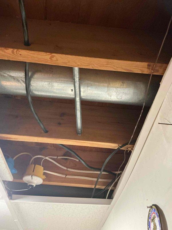 Conducted an on-site evaluation for installing an EV charger, inspecting the main electrical panel, which was found in good condition with no signs of rust or damage and with breaker slots and circuit labeling documented. Examined the overhead ceiling cavity to assess potential cable routing paths, noting existing wiring, junction boxes, and ductwork that will affect the run from the panel to the charger location. Findings were recorded to support a load assessment and installation estimate.