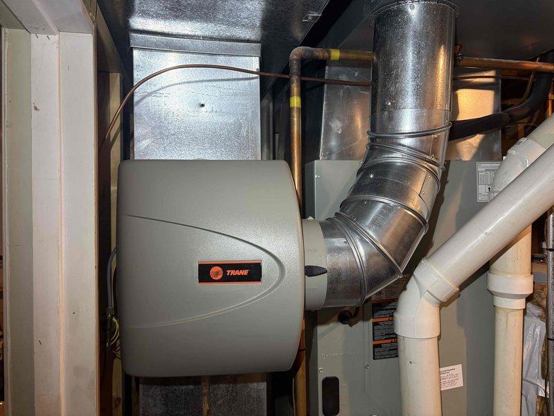 Performed a heating tune-up on a 7-year-old furnace and humidifier, inspecting the system components, ductwork, condensate piping, and refrigerant line connections, with no signs of damage, rust, or leaks observed. Evaluated the pleated air filter, which showed discoloration and uneven, compressed pleats indicating loading, and addressed it as part of the maintenance. System was left operating normally.