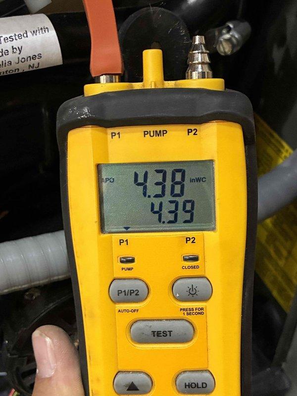 Performed annual heating tune-up on an 11-year-old Trane heat pump and furnace system that was operating normally. Inspected the outdoor condenser unit, finding it clean, intact, and free of frost, ice, rust, or damage, and verified system performance with a digital manometer, with pressure readings of 4.38 and 4.39 inWC showing stable, balanced results. System is operating properly with no deficiencies noted.