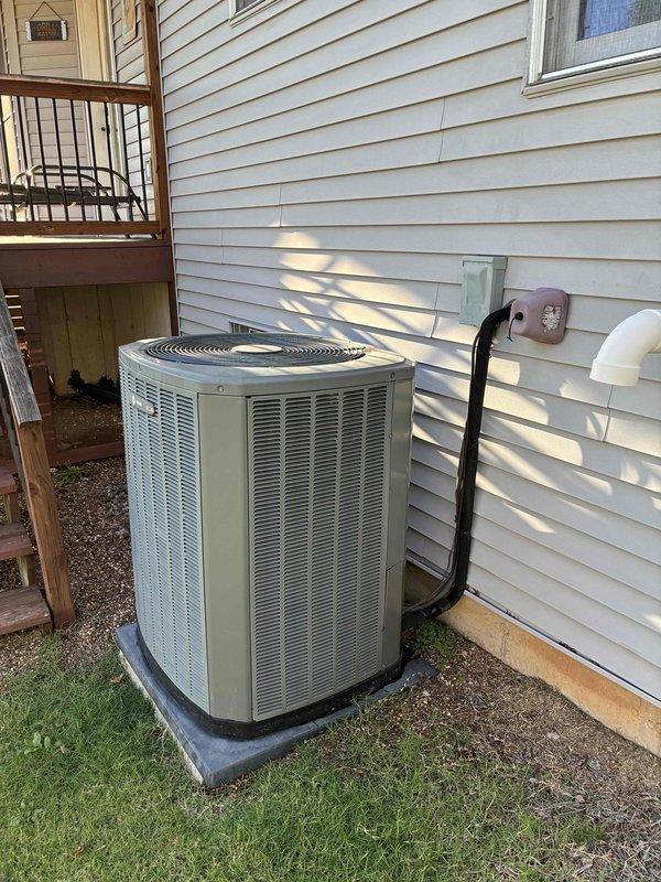 Performed annual heating tune-up on an 11-year-old Trane heat pump and furnace system that was operating normally. Inspected the outdoor condenser unit, finding it clean, intact, and free of frost, ice, rust, or damage, and verified system performance with a digital manometer, with pressure readings of 4.38 and 4.39 inWC showing stable, balanced results. System is operating properly with no deficiencies noted.