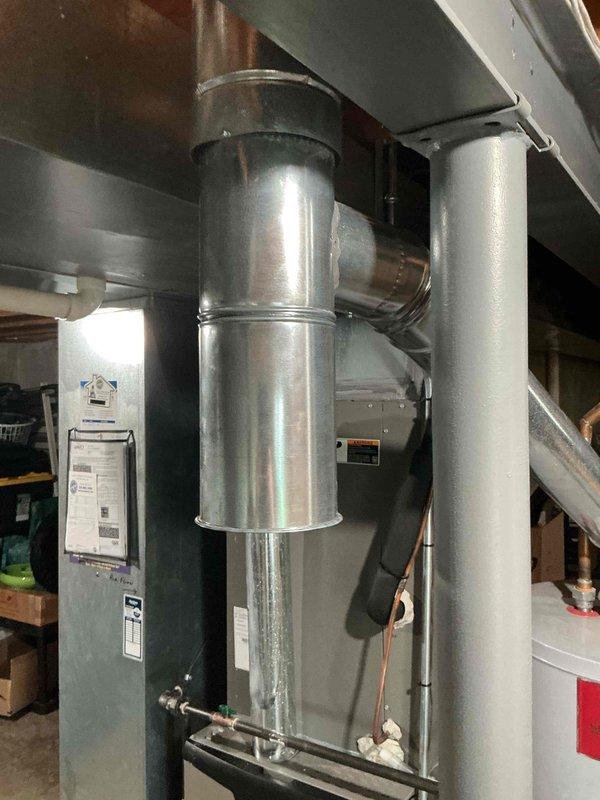 Replaced the galvanized flue tee (5"x4"x5") in the vent connector assembly serving the gas appliances, ensuring secure, properly sealed joints and correct flue alignment to the vertical vent. Verified the new fitting was fastened and supported so combustion byproducts exhaust safely through the venting system.