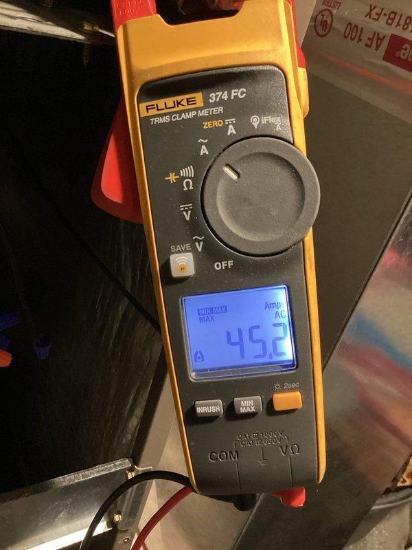 Following up on an HVAC request to verify breaker sizing, inspected the 200A main service panel and found the enclosure dry and undamaged, with orderly conductor terminations and no signs of burning, corrosion, or physical damage. Measured the HVAC unit's operating load with a Fluke 374 FC TRMS clamp meter, recording 45.2 amps AC, to evaluate whether the existing breaker is appropriately sized for the equipment's demand.