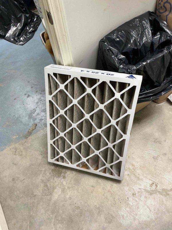 Performed a furnace tune-up on one unit, including inspection of the system, flue piping, and ductwork connections, which showed no rust, damage, or leakage. Removed the heavily soiled 20x25x4 pleated air filter and replaced it to restore proper airflow, and cleared the removed filter and debris from the work area.