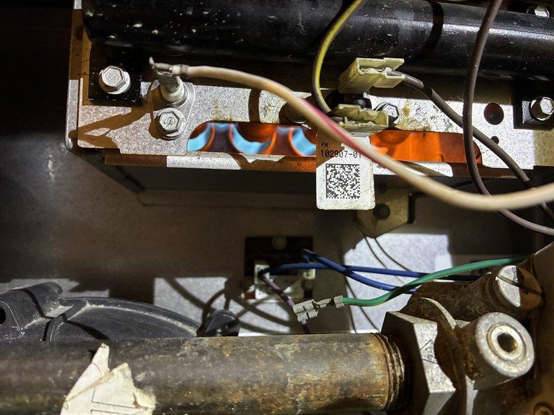 Performed routine heating tune-up on a 10+ year-old gas furnace and ductless unit, inspecting the burner assembly, gas valve, inducer motor, pressure switch, venting, and wiring connections. Found heavy rust and corrosion on the gas supply piping and fittings near the burner assembly, along with staining on the burner housing and a disconnected crimp terminal on a green wire; recommend further evaluation and repair of the corroded gas piping. System was operating properly at the time of service.
