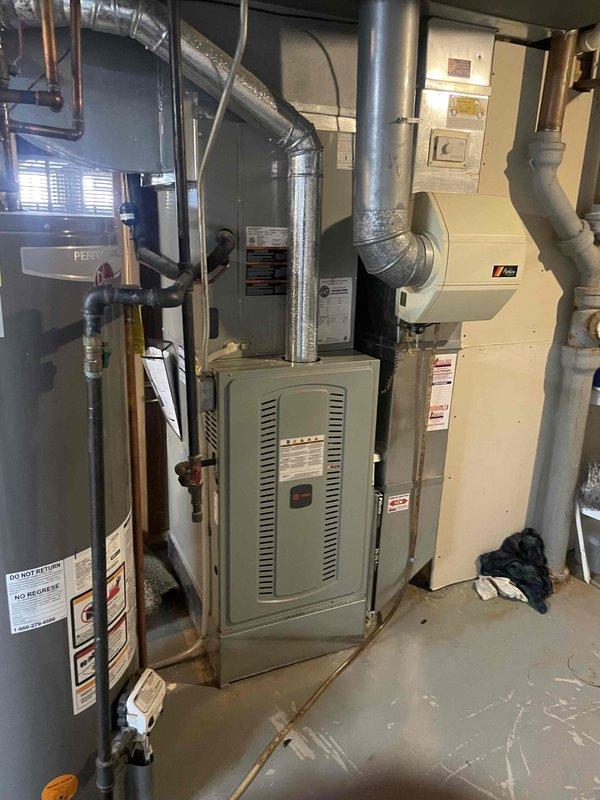 Performed a seasonal tune-up on the gas furnace, inspecting the cabinet interior, ductwork connections, and burner compartment, and verified blower motor amperage with a clamp meter (4.49 A AC) to confirm operation within normal parameters. The equipment showed no signs of frost, leaks, or significant damage, though minor corrosion was noted on a sheet metal edge inside the cabinet. The system is operating normally upon completion.