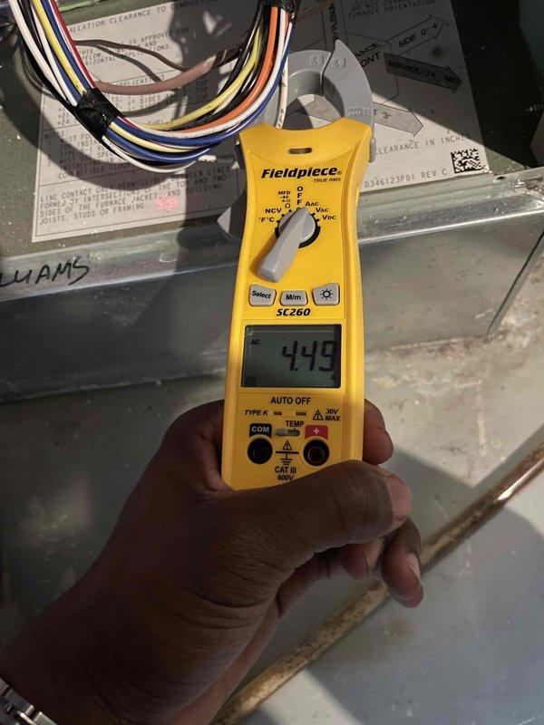 Performed a seasonal tune-up on the gas furnace, inspecting the cabinet interior, ductwork connections, and burner compartment, and verified blower motor amperage with a clamp meter (4.49 A AC) to confirm operation within normal parameters. The equipment showed no signs of frost, leaks, or significant damage, though minor corrosion was noted on a sheet metal edge inside the cabinet. The system is operating normally upon completion.