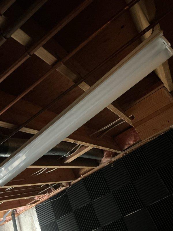 Performed an on-site evaluation for an electrical fixtures estimate, including assessing a room with no existing lighting to determine wire routing from the unfinished basement ceiling joist cavity, inspecting non-functioning light fixtures in a second room, and reviewing a multi-button fan control wall plate along with a dimmer switch slated for removal. Scope of work was documented with photographs to support the proposed installation of new lighting circuits, troubleshooting of the inoperative fixtures, and dimmer switch uninstallation.