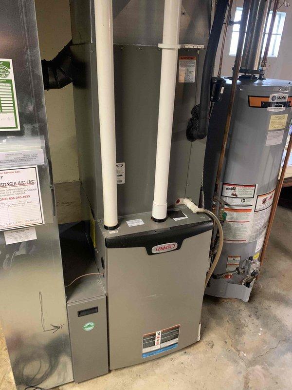 Performed a heating tune-up on a Lennox condensing gas furnace, inspecting the cabinet, PVC intake/exhaust venting, condensate drain line, and ductwork connections for proper installation and condition, with no visible rust, leaks, or damage. Measured blower motor amperage with a true RMS clamp meter, recording 0.26 A, and verified the unit was operating normally.