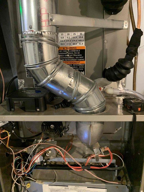 Responded to a no-heat call on a 9-year-old gas furnace that would not light. Inspection of the unit revealed a heavily corroded flue/vent passage with significant rust scale and mineral deposits, restricting proper venting and preventing safe ignition. The furnace was evaluated for combustion and venting safety, and repair or replacement of the deteriorated venting components is recommended to restore safe, reliable heating operation.