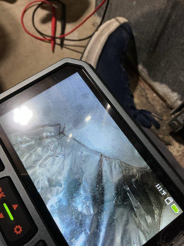 Responded to a no-heat call on a gas furnace presenting with a buzzing sound, no inducer motor activation, and a 3-flash fault code on the control board status light. Inspected the system, including supply ductwork temperature readings and a borescope inspection that revealed a tear in the foil-wrapped duct interior, and diagnosed the inducer/pressure switch circuit fault as the cause of the heat failure. Photo documentation of the findings was captured for the service record.