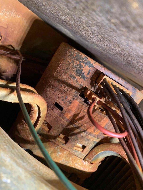Responded to a no-heat call on a 10+ year old basement furnace that was failing to ignite and found the inducer/draft motor and surrounding cabinet components heavily corroded, with rust and mineral buildup on the motor housing, mounting brackets, and the flue/vent assembly. The corrosion is consistent with moisture exposure and condensate intrusion and is preventing proper ignition sequence operation. Documented all conditions with photos and advised on the unit's condition and recommended repair or replacement options.