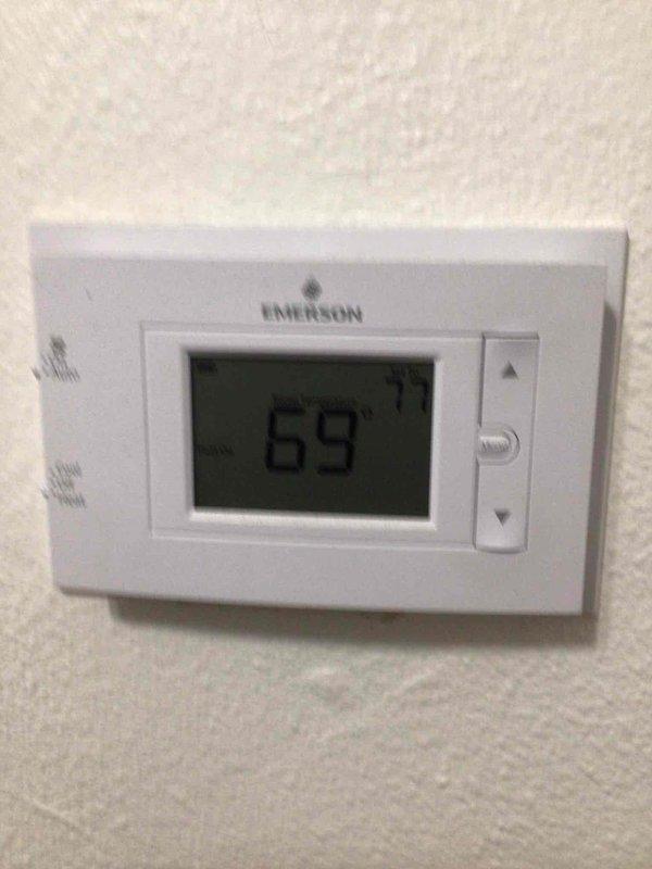 Performed a seasonal tune-up on a single gas furnace, removing the upper access panel to inspect the control board, wiring harness, gas valve, inducer assembly, and flue connection, with no visible corrosion, damage, or loose connections noted. Verified thermostat operation and calibration, confirming proper call for heat and system response.