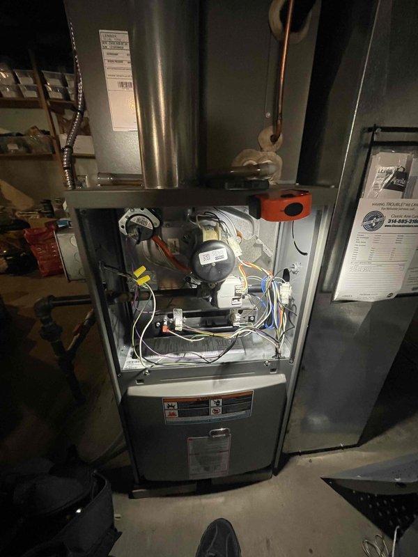Performed a seasonal tune-up on a single gas furnace, removing the upper access panel to inspect the control board, wiring harness, gas valve, inducer assembly, and flue connection, with no visible corrosion, damage, or loose connections noted. Verified thermostat operation and calibration, confirming proper call for heat and system response.