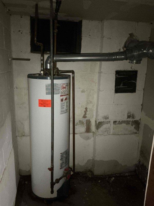 Removed the leaking gas tank-style water heater and converted the system to a tankless unit, including new gas, water, and venting connections. Disconnected and drained the old unit, installed and secured the tankless heater, then pressure-tested the connections, checked for gas leaks, and verified proper ignition and operation.