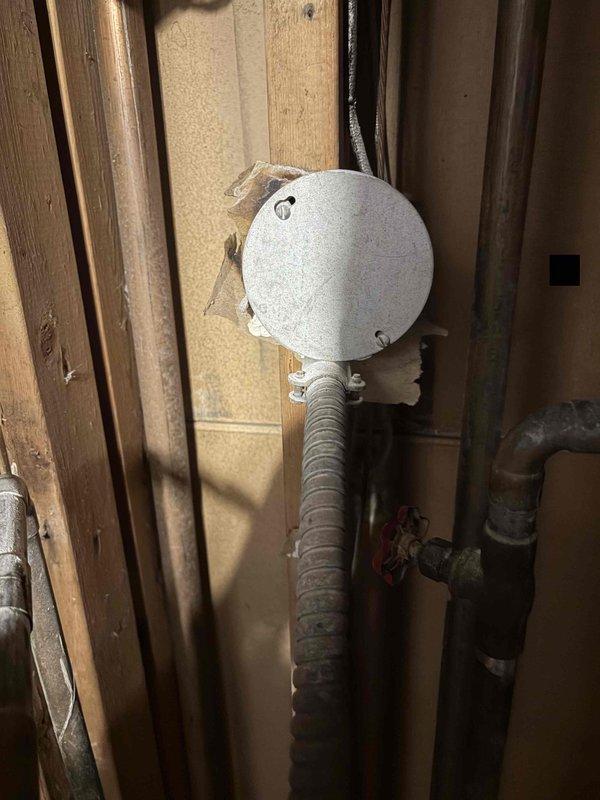 Removed and replaced the existing tanked water heater with a new 30-gallon lowboy blanketed electric unit under permit. Installed a 6' flexible conduit whip from the existing junction box behind the unit to make the electrical connection, and replaced a heavily corroded bracket found in the wall cavity. Completed all plumbing and electrical connections and verified proper operation.