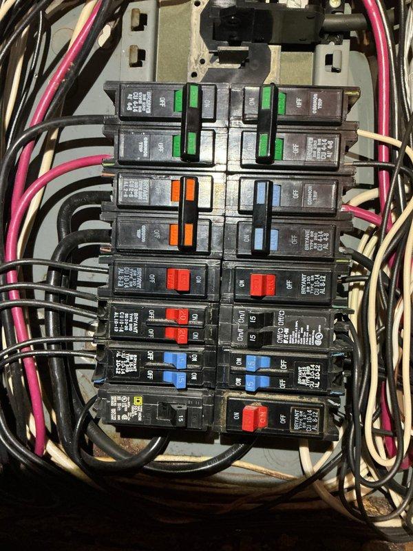 Responded to a bedroom outlet and switch malfunction by inspecting the residential electrical system, including the main breaker panel and associated branch circuits. Opened and evaluated the panel, noting dense, disorganized conductor routing, mixed-brand breakers (Bryant, Eaton, Square D), tandem breakers, and dirt and corrosion-related discoloration, and verified circuit labeling for the bedroom circuit. Documented panel conditions with photos and recommended further evaluation of the panel's condition and wiring.