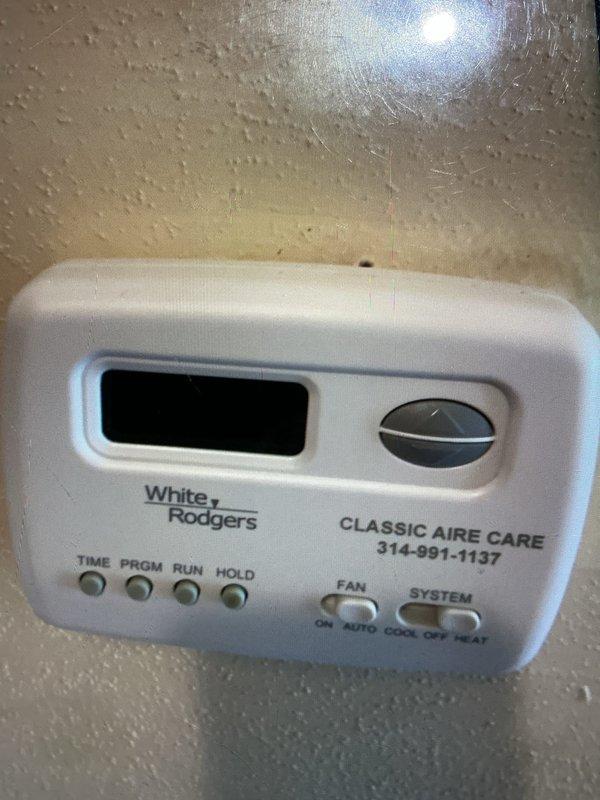 Responded to a no-heat call with no blower operation on a 15-year-old gas furnace and removed the access panel to perform electrical diagnostics on the control circuit, draft inducer assembly, and low-voltage wiring using a multimeter and clamp meter. Verified the thermostat display was blank, indicating a loss of low-voltage power to the control system, and traced the circuit to isolate the cause of the lack of heating and airflow demand.