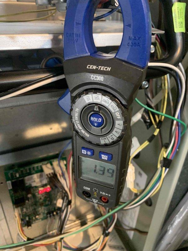Performed a heating tune-up on a 6-year-old furnace, including inspection of the electrical compartment and measurement of component amperage draw with a clamp meter (1.39A reading). Removed and inspected the return air filter, which was heavily loaded with dust and debris, and noted it requires replacement to restore proper airflow and system efficiency.