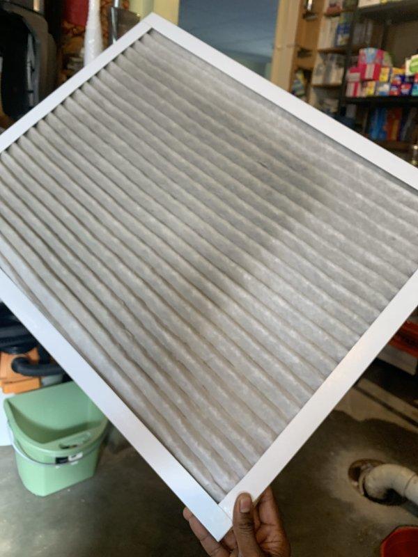 Performed a heating tune-up on a 6-year-old furnace, including inspection of the electrical compartment and measurement of component amperage draw with a clamp meter (1.39A reading). Removed and inspected the return air filter, which was heavily loaded with dust and debris, and noted it requires replacement to restore proper airflow and system efficiency.