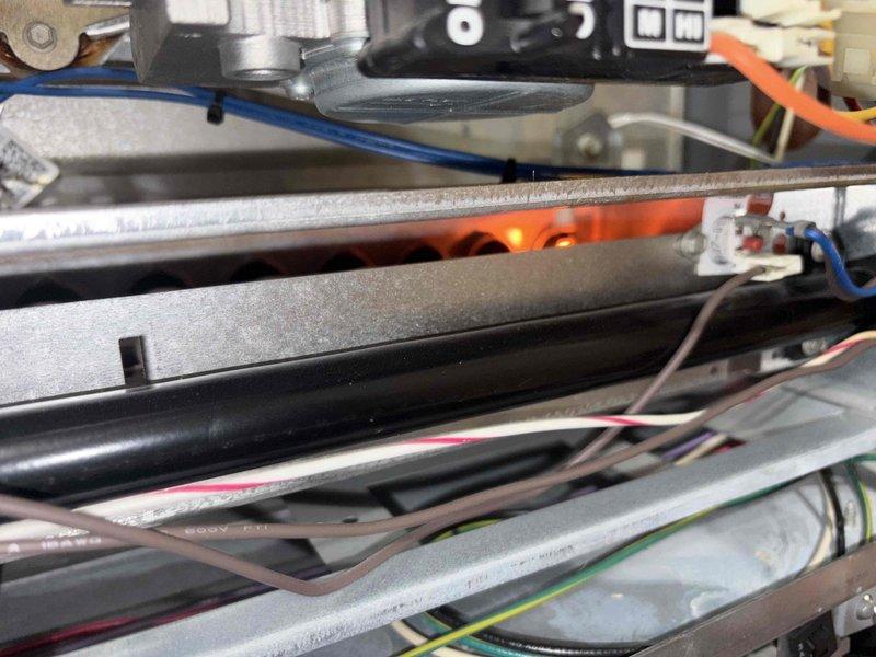 Responded to a no-heat call on a single furnace reporting an igniter-related error code. Inspected the burner assembly and gas valve area, where the igniter was glowing and the burners were energizing, then checked the integrated control board, its wiring harness, and splice connections, which showed cluttered wiring and wire-nut splices. Verified igniter and ignition-sequence operation and confirmed the furnace was cycling and producing heat at completion.