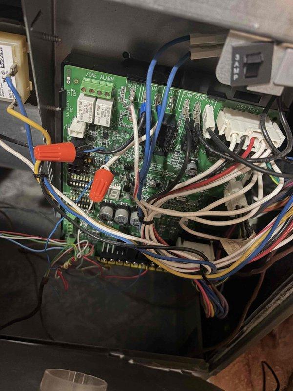 Responded to a no-heat call on a single furnace reporting an igniter-related error code. Inspected the burner assembly and gas valve area, where the igniter was glowing and the burners were energizing, then checked the integrated control board, its wiring harness, and splice connections, which showed cluttered wiring and wire-nut splices. Verified igniter and ignition-sequence operation and confirmed the furnace was cycling and producing heat at completion.