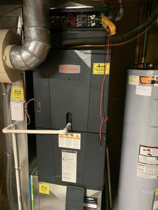 Performed a heating tune-up on one Trane upflow furnace/air handler, including inspection of the electrical compartment and amperage testing of components with a clamp meter. Inspected the return air filter and housing, confirming the pleated media was intact and lightly dusty with no tears. Verified condensate drain piping, ductwork connections, and refrigerant line insulation were in good condition, and the system was left operating properly.