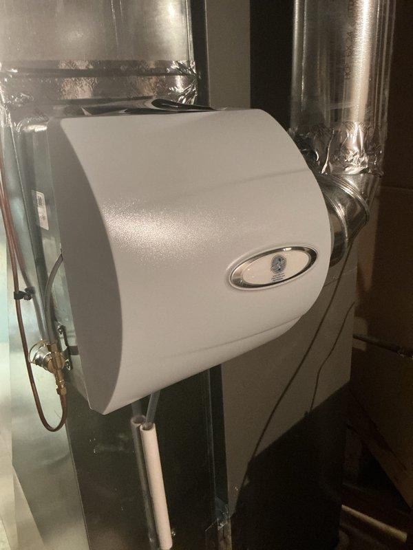 Performed a routine seasonal heating tune-up on the Lennox furnace, inspecting and servicing the system for safe, efficient operation with no issues reported. Inspected the bypass-style whole-home humidifier mounted on the supply duct, including the saddle valve supply line, drain line, and flexible duct connection, and found the unit and ductwork clean and intact with no signs of rust, leaks, or damage. System left operating normally.