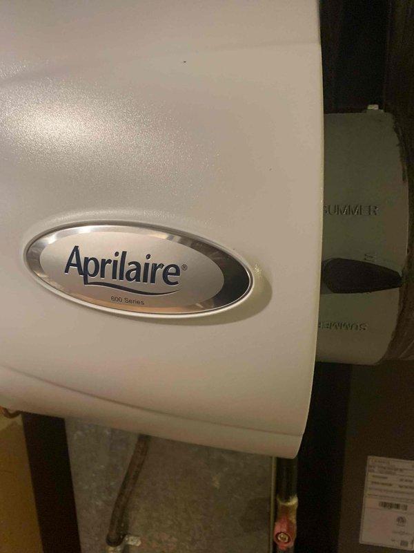 Performed a heating tune-up on the 9-year-old furnace, including inspection and servicing of the unit and associated components. Inspected the Aprilaire 600 Series whole-home humidifier and found the water supply line and valve intact with no visible damage, rust, or leaks. Removed and replaced the dirty, stained humidifier drain tubing and fitting.